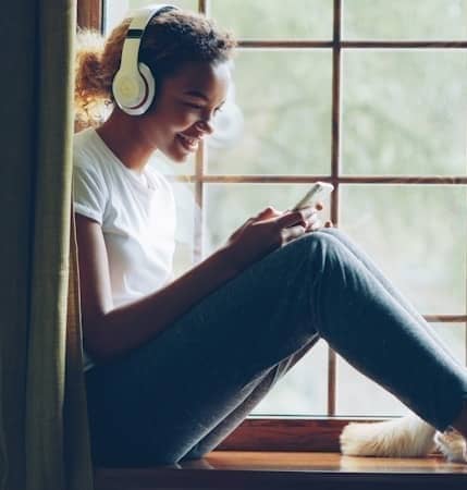 Woman listens to music with her dog.