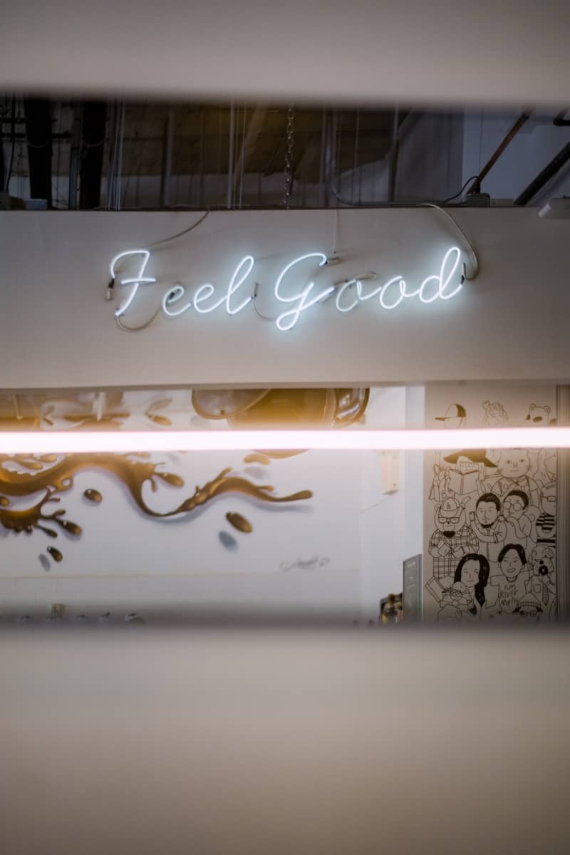 a store front with a neon sign above it