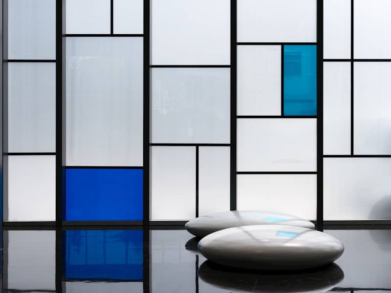 A room with a large window and a white chair