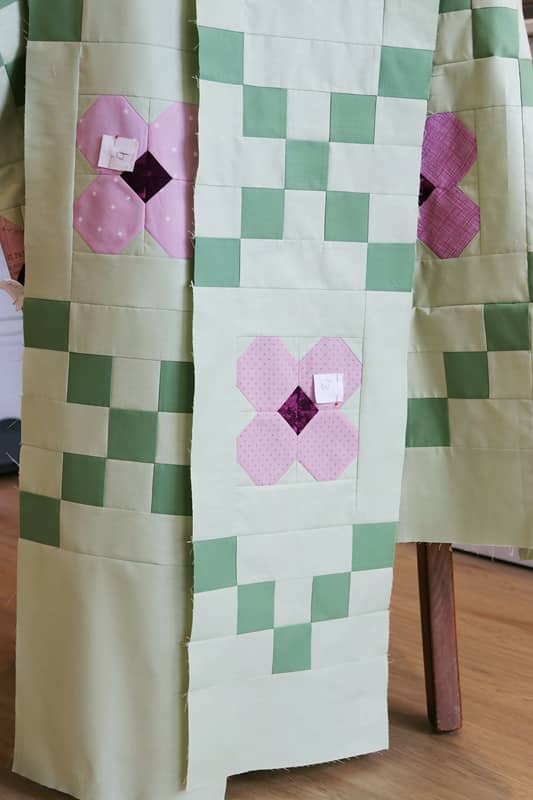 Rows of patchwork ready to be sewn into a floral Irish Chain quilt
