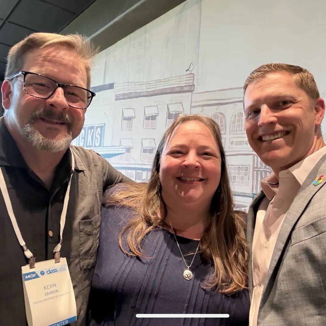 Three colleagues stand together for a selfie following a conference presentation Left to right, they are: Kevin Gannon, Liz Norell, and Kevin McClure.