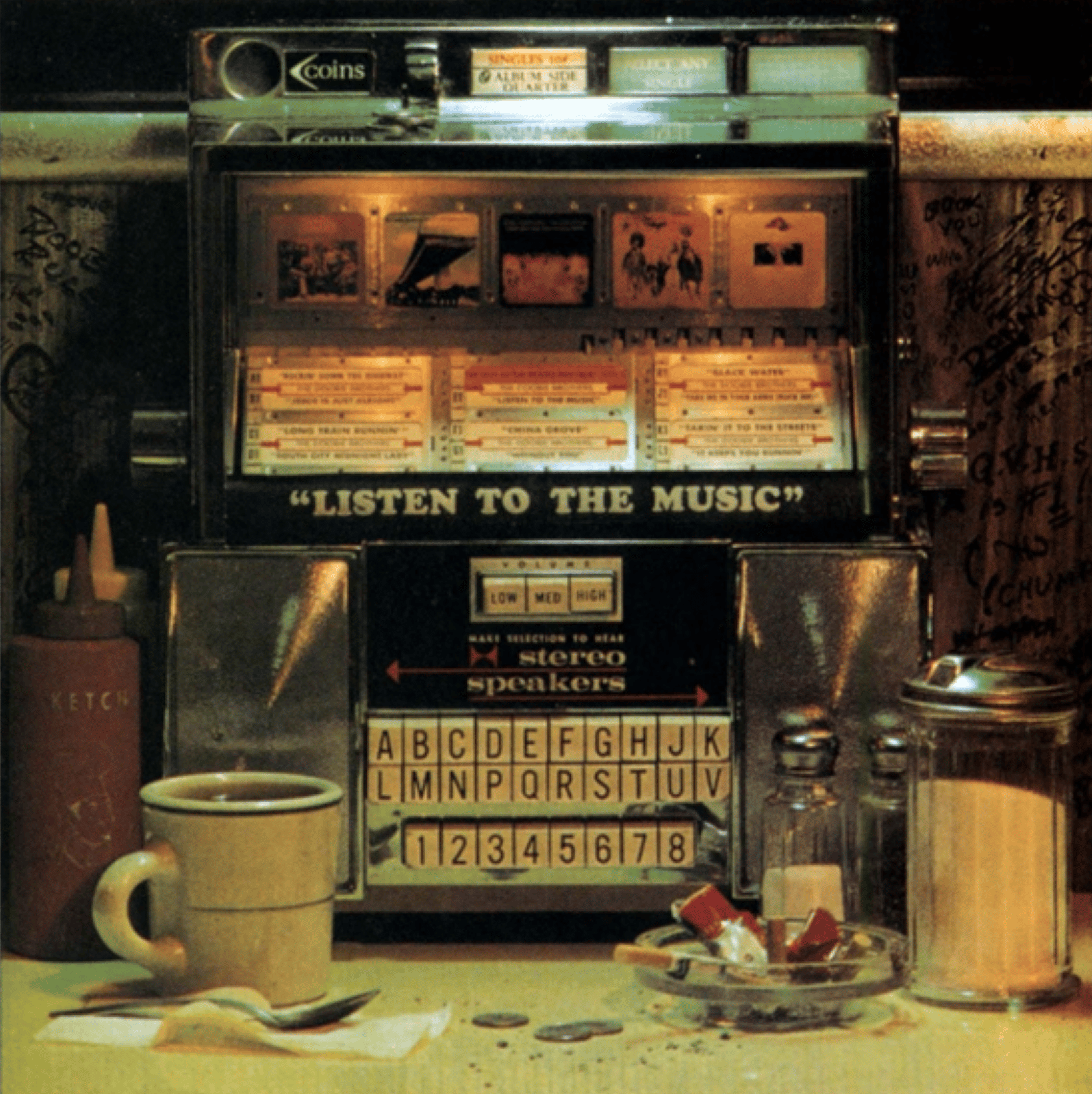 Album cover with a jokebox in the background with the words: "Listen to the music" displayed on the front of it. 