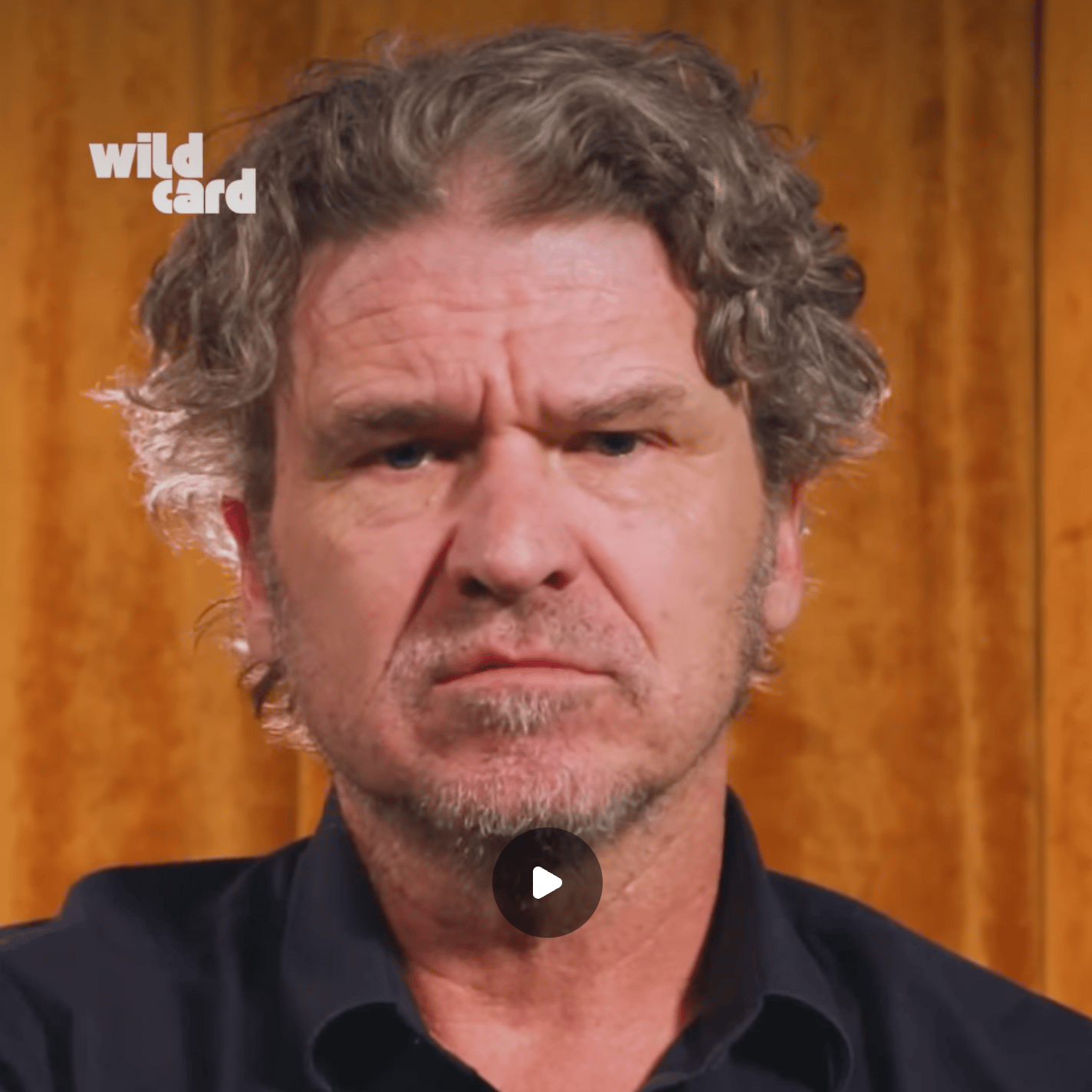 Man looks sternly and seriously at the camera