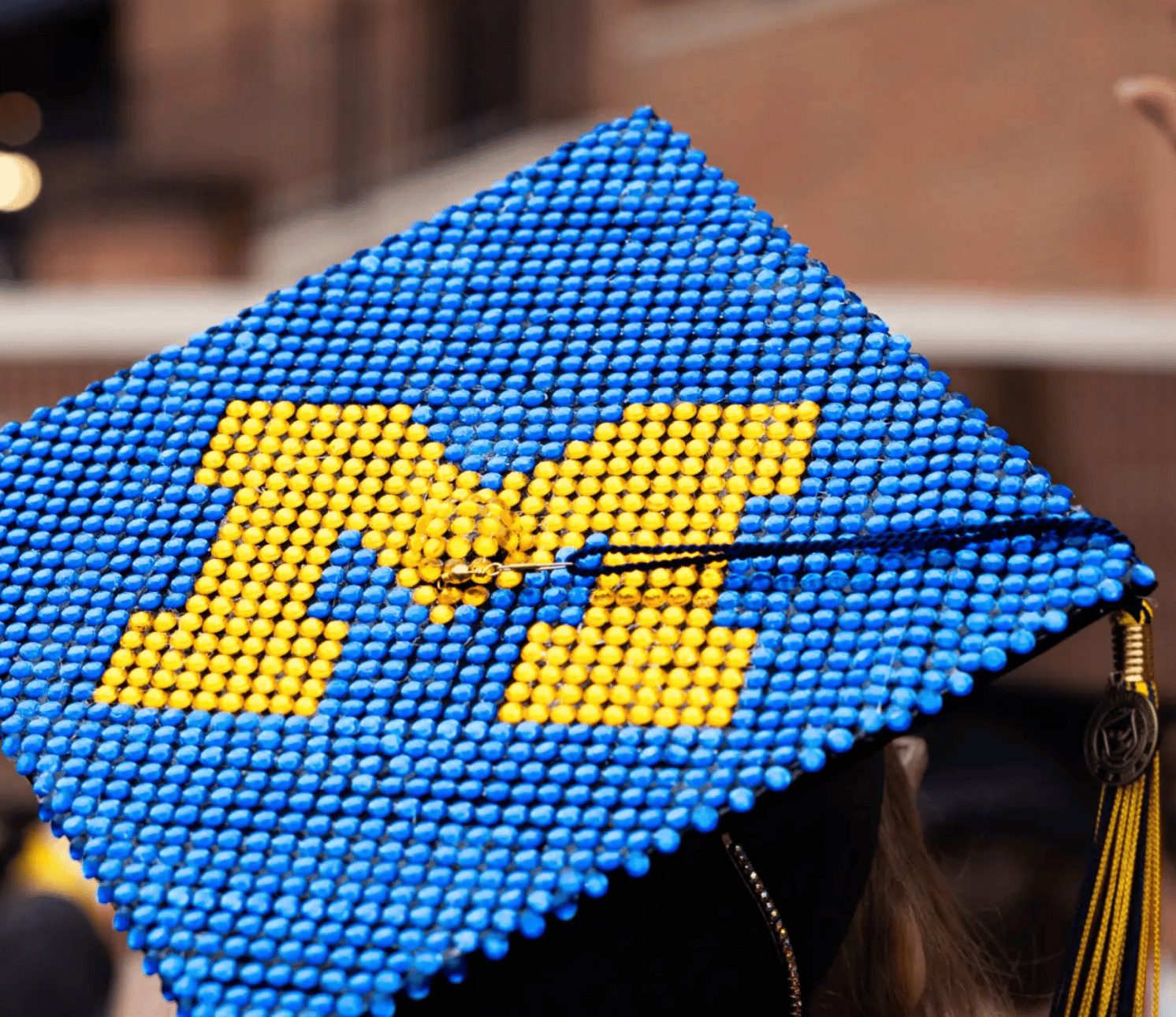 University of Michigan graduation hat (perhaps created using small poofs/balls, but hard to tell how this artist did their work)