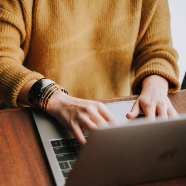 Person typing on a laptop keyboard