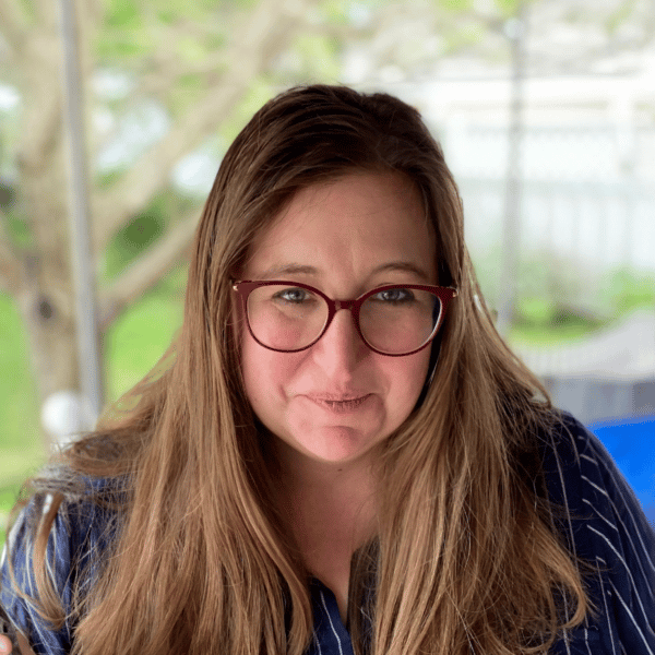 Bethany's headshot, she has long, straight hair and wears glasses
