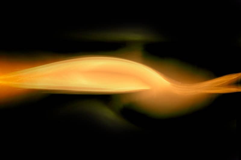 Abstract light waves glow against a dark background.