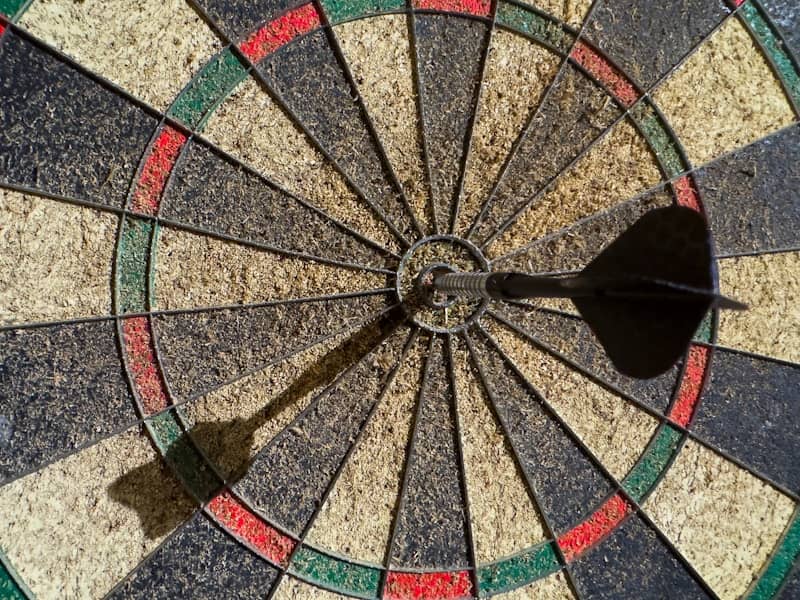 Dartboard with a dart in the bullseye