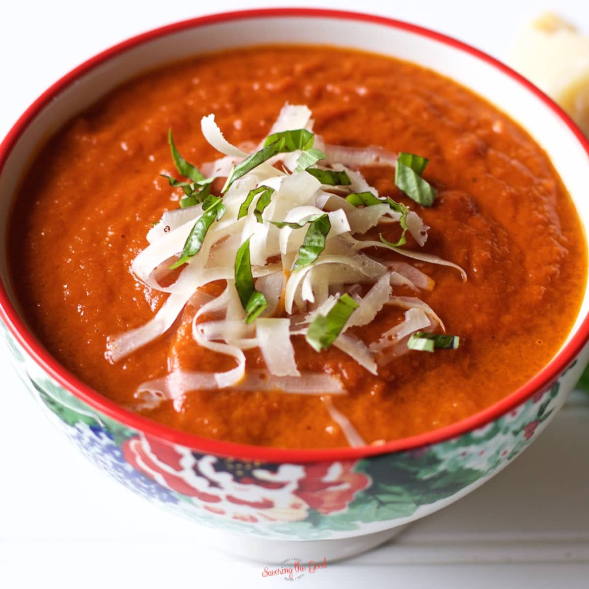 tomato soup with shredded cheese in a bowl.