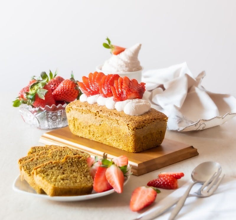 brown and white cake with strawberry on top