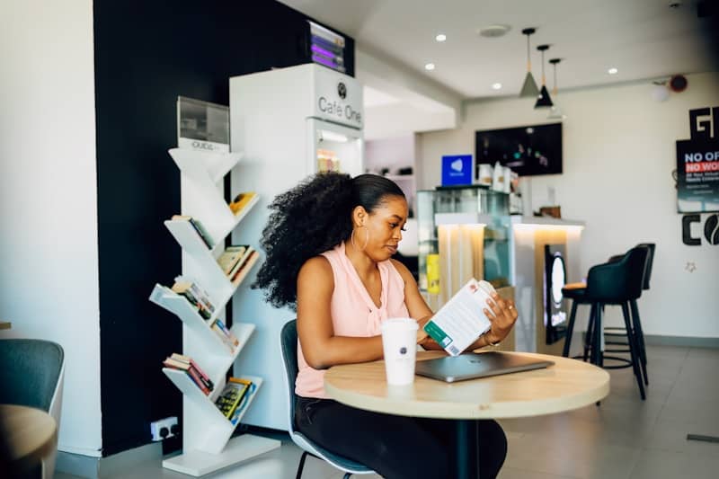 A woman sitting at a table with a laptop