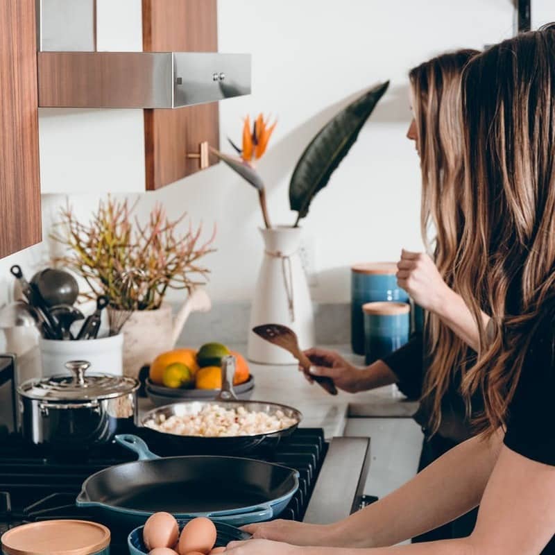 two woman on kitchen cooking