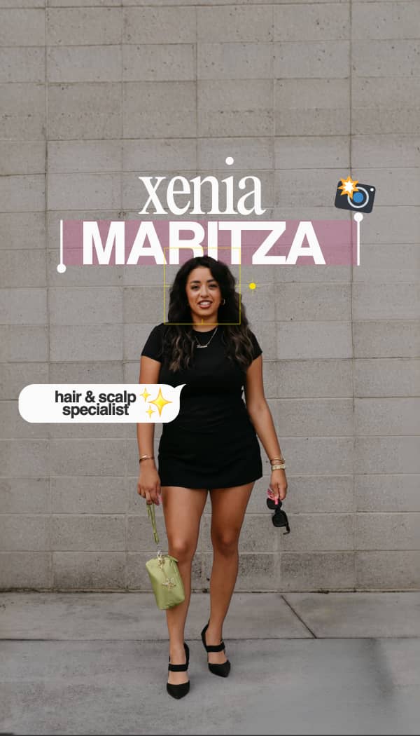 Five people standing with their backs facing the camera, showcasing their long, wavy hairstyles. They wear various outfits including jeans, a skirt, and leather jackets. The background is a plain dark wall.