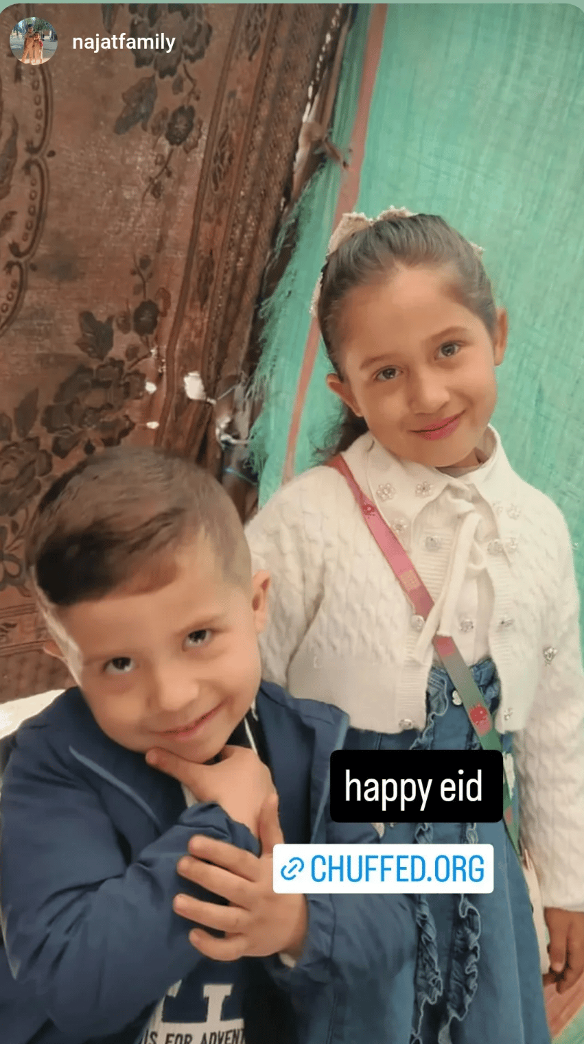 Nourhan's children Najat and Muhammad pose in their new Eid outfits.