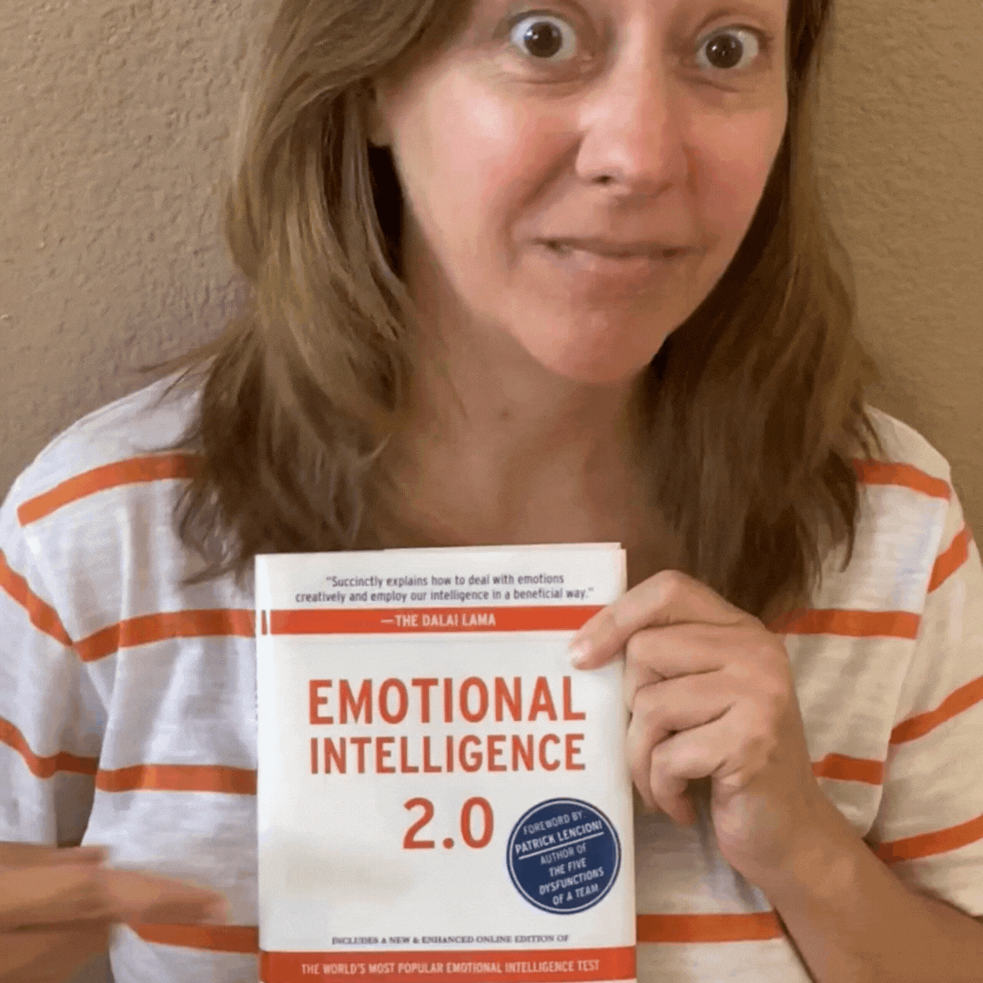 Stephanie pointing at the book "Emotional Intelligence 2.0"