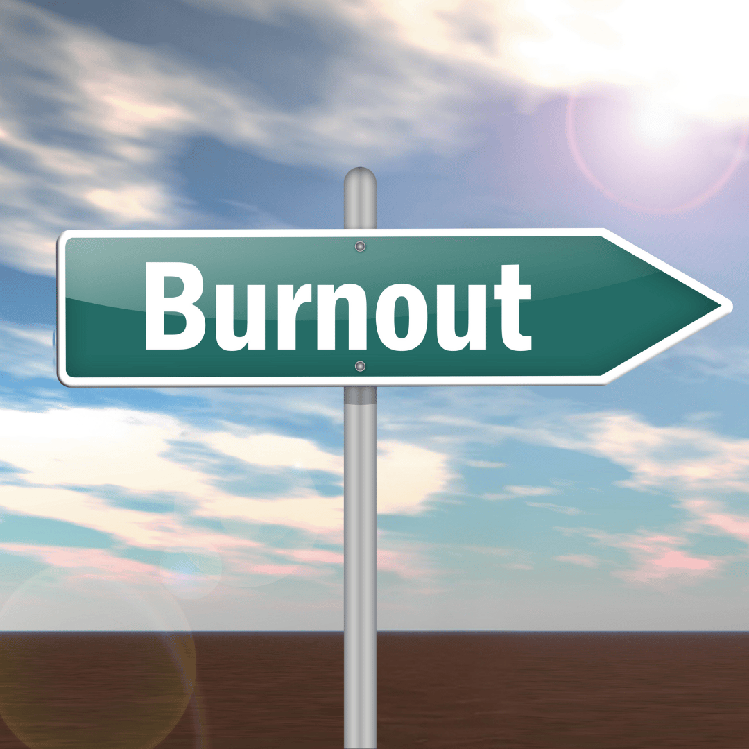 A road sign that reads "Burnout" is pointing forward against a harsh, sunny sky.