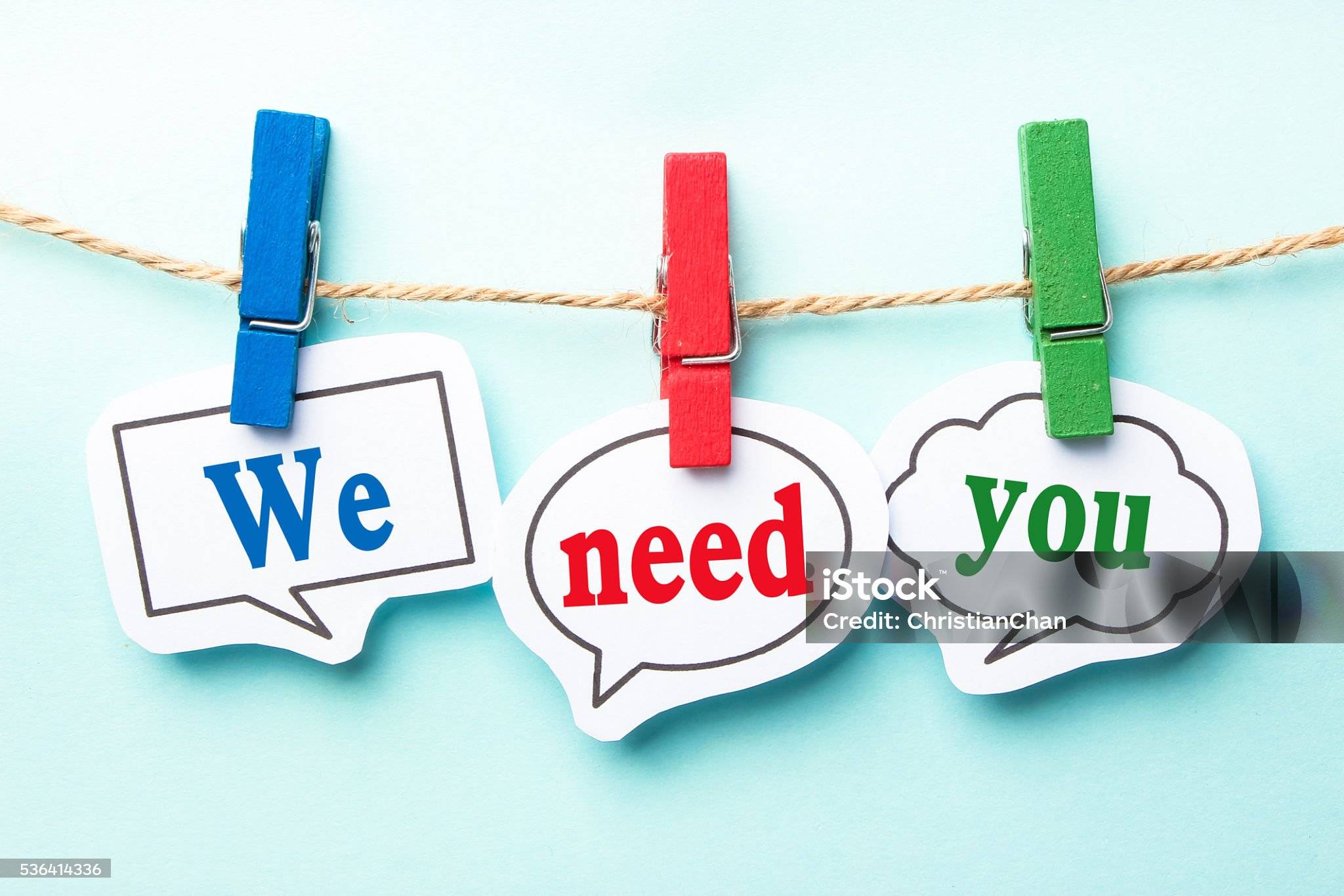 The words "We", "need", and "you" are shown in their own word bubble cutouts, hung up on a string with clothespins.