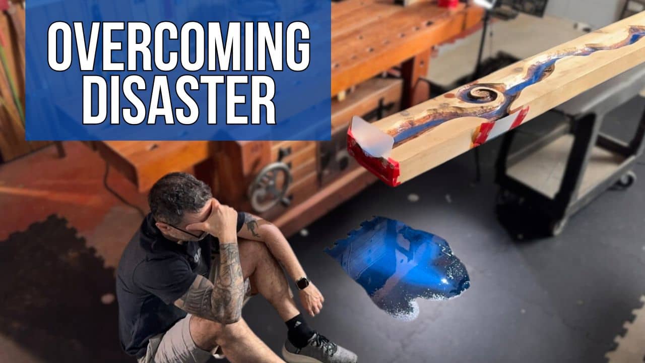 Marc sitting on the shop floor next to spilled epoxy