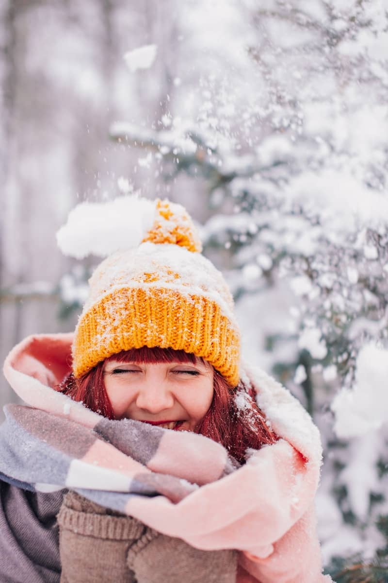 girl in white winter coat and brown knit cap