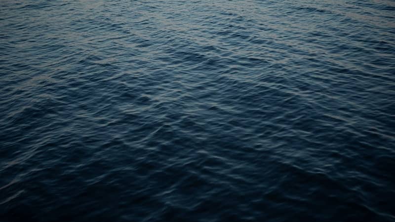 A large body of water with a sky in the background