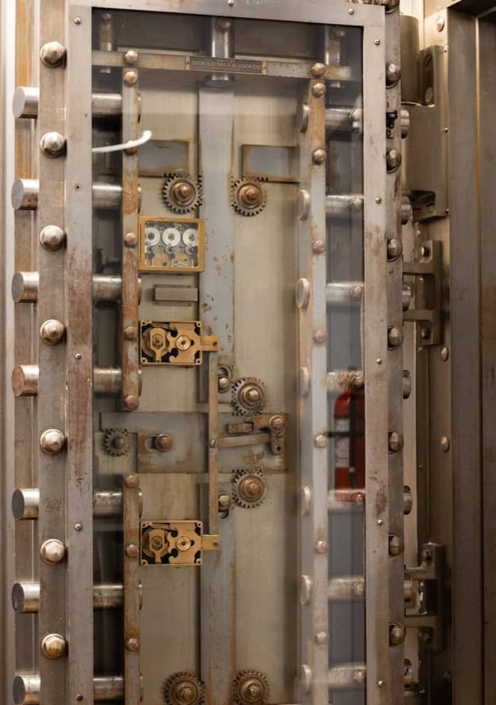 A metal door with a bunch of knobs on it