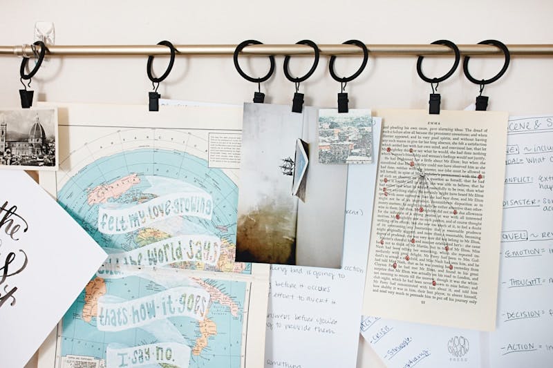 white printer papers hanging on brown metal rod