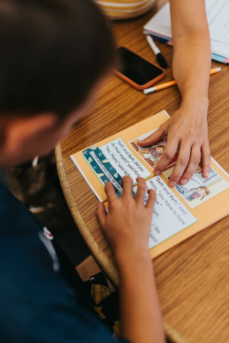 Two people learning together at a wooden table
