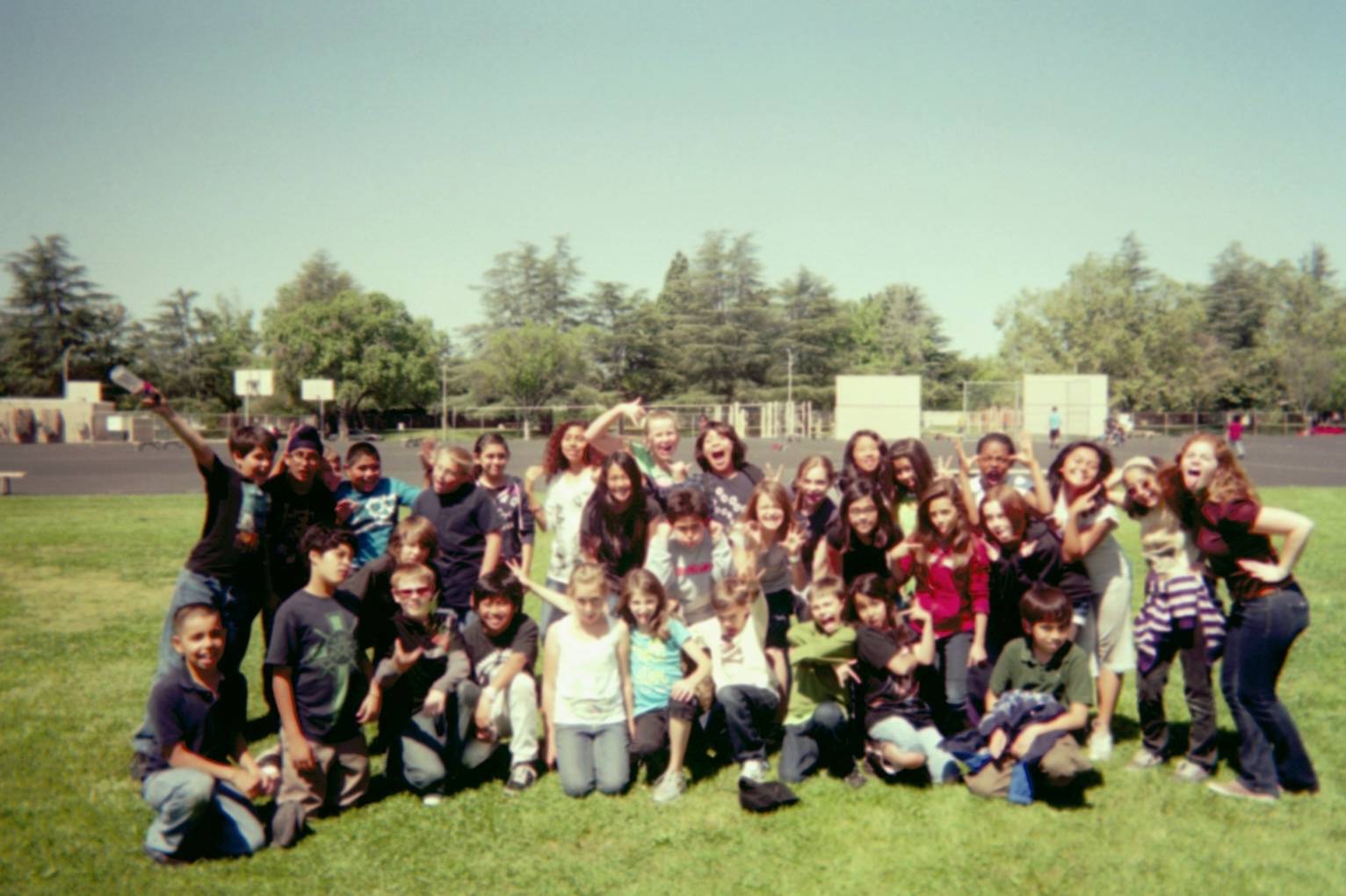 Natalie Poses with 5th Graders in a Grainy Disposable Camera Pic