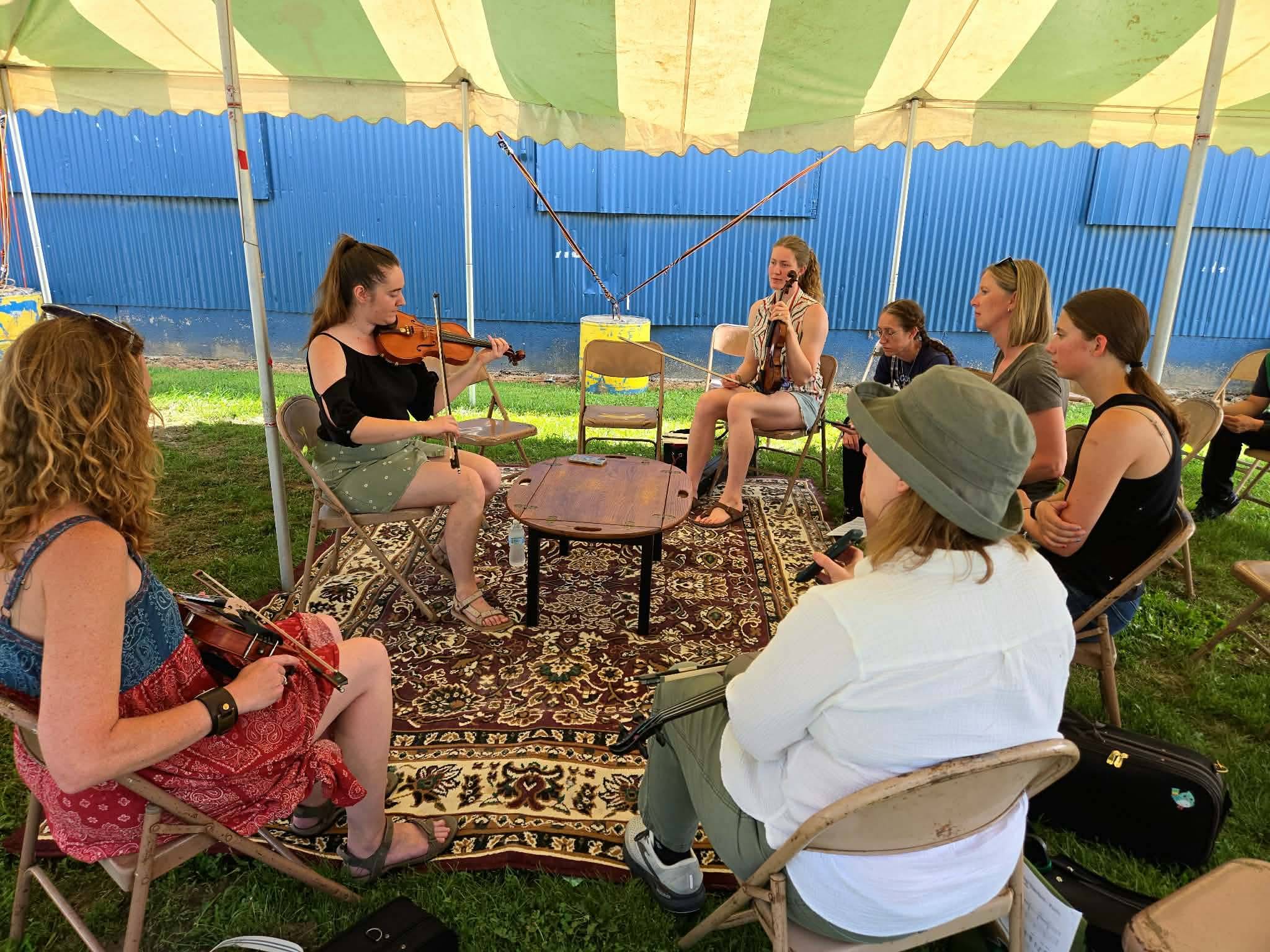 Hannah teaching a fiddle class under a tent at Michigan Celtic Fest
