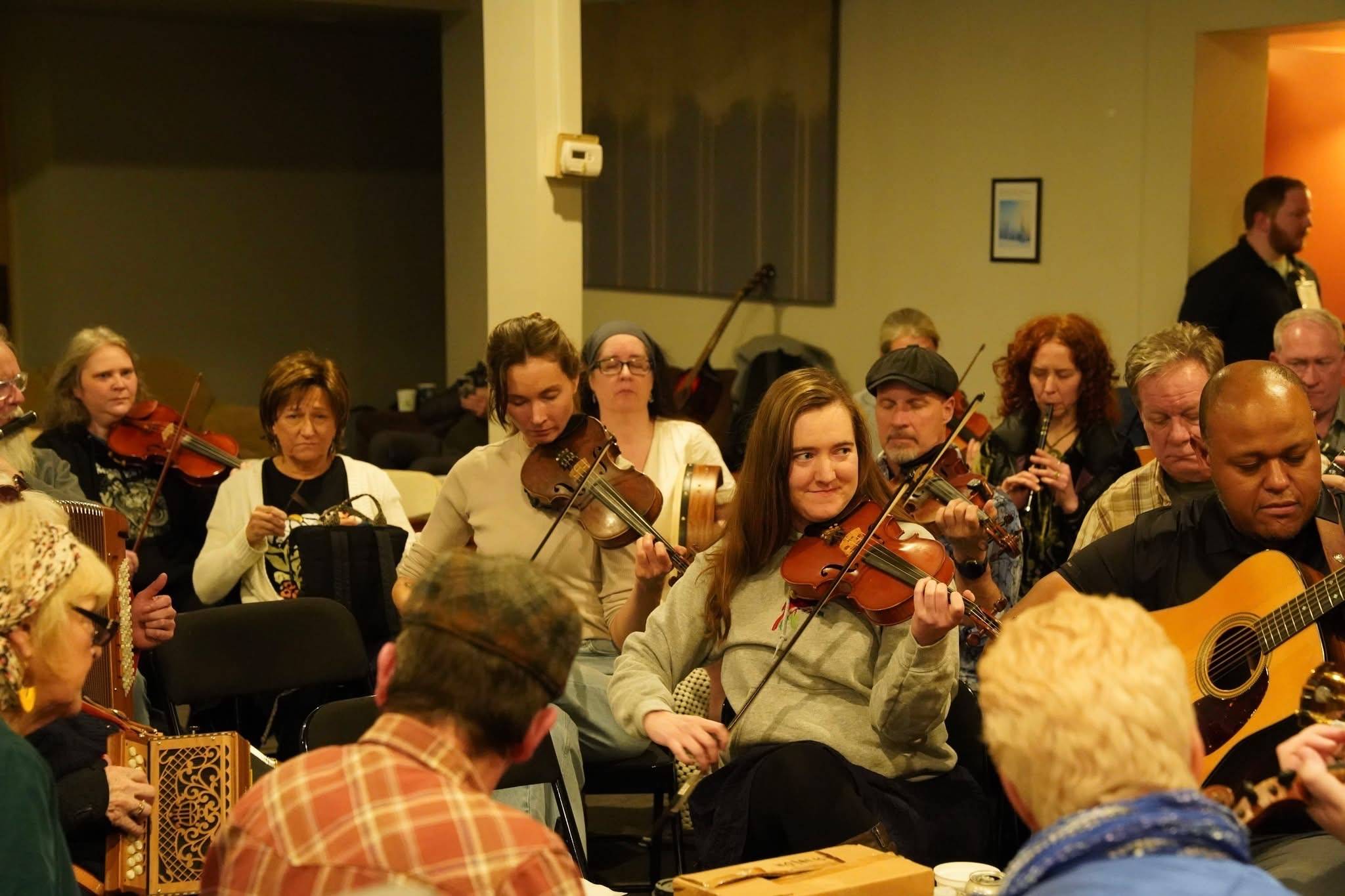 A group of musicians all playing tunes together in a circle
