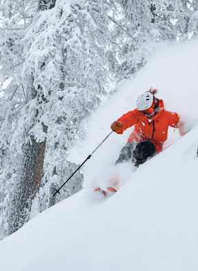 man downhill skiing in deep snow at Taos Valley 