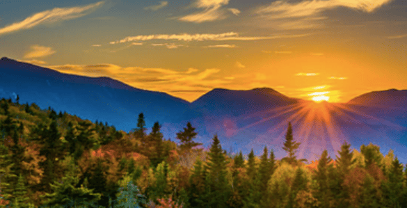 sunrise coming up over a mountain range