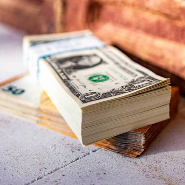 a stack of money sitting on top of a table