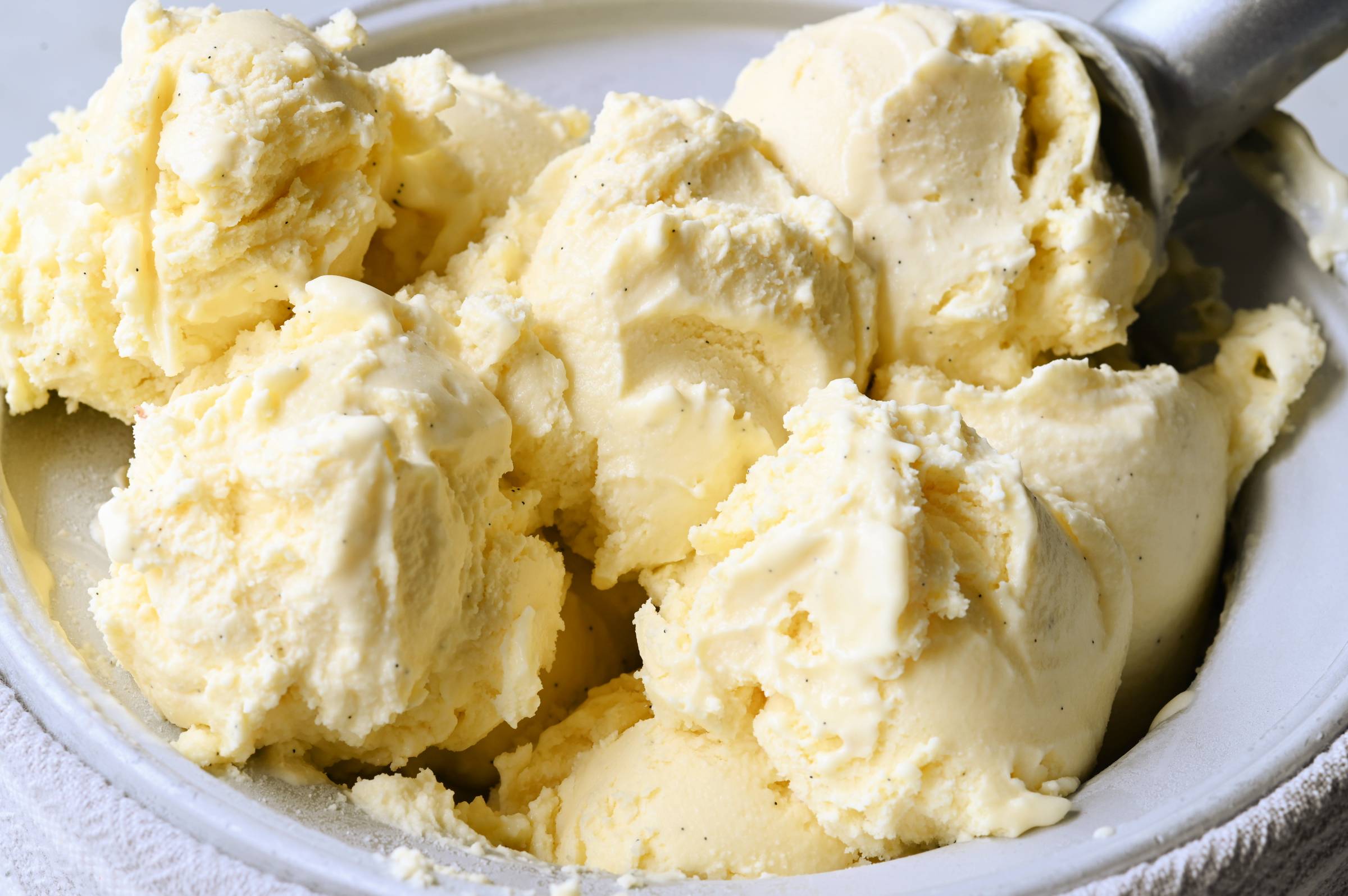 Homemade French vanilla bean ice cream with visible vanilla specks in a bowl.