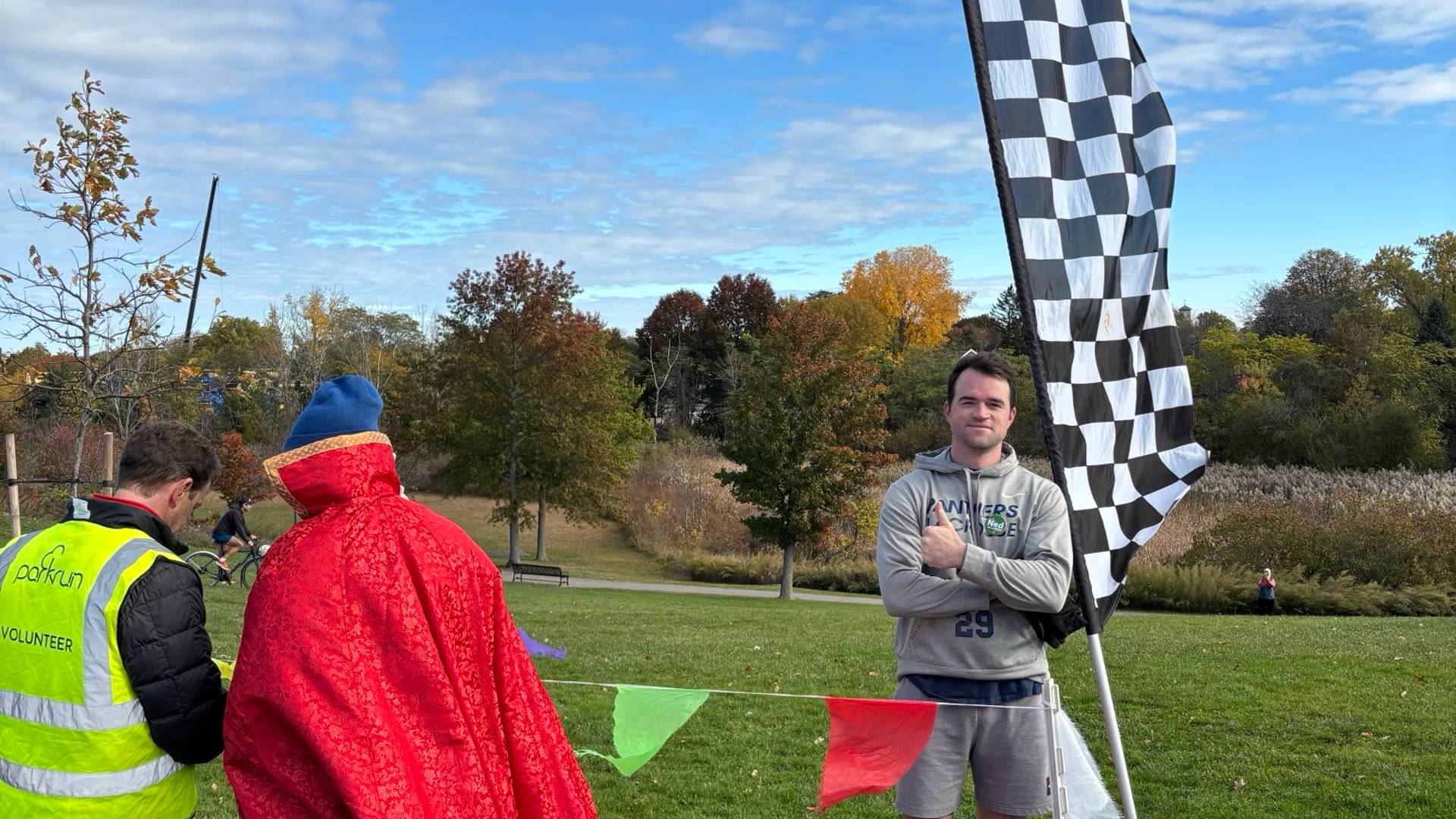 Posing at the Halloween Park Run finish line with a volunteer and Doctor Strange
