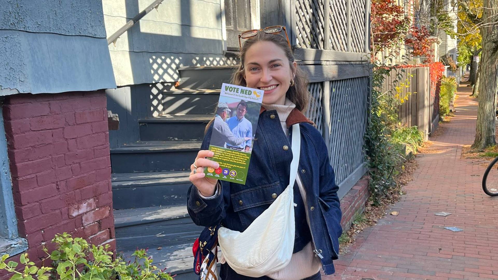 Sophia holding up her "Vote Ned" palm card
