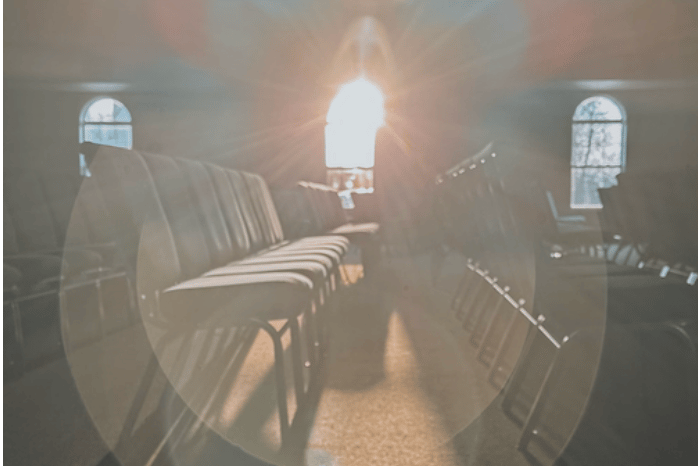 church row with sunlight shining through large windows