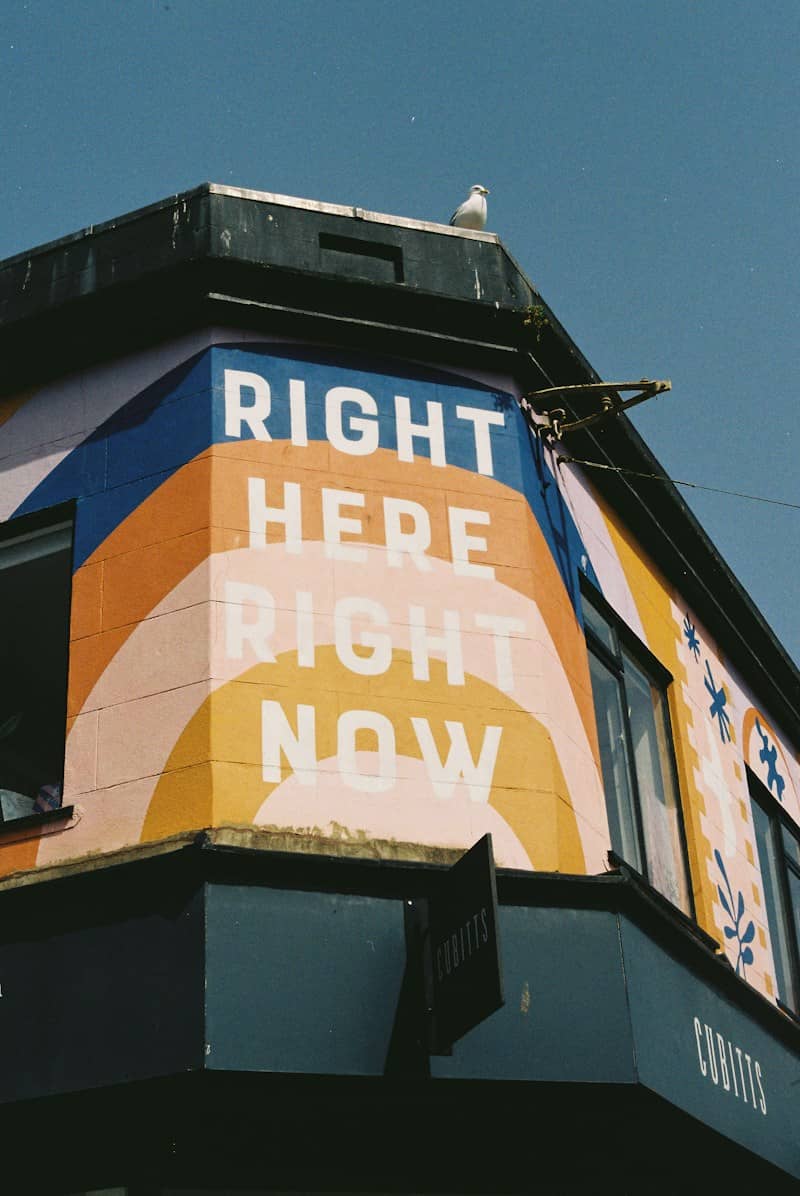 Vibrant mural with text: right here right now