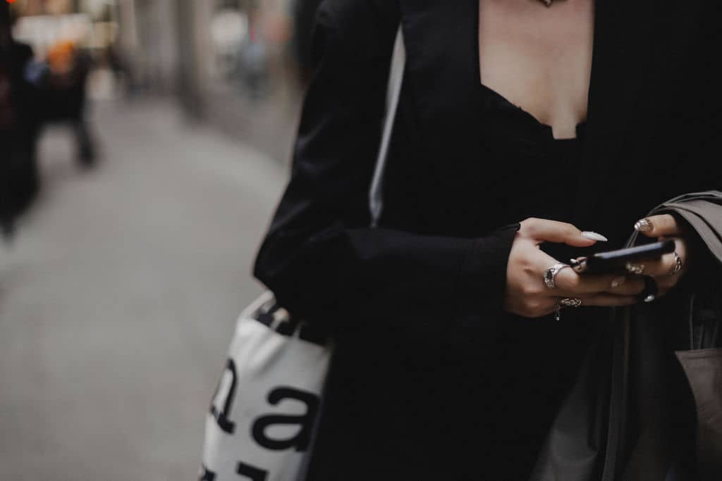 woman walking and looking something up on her phone; decorative
