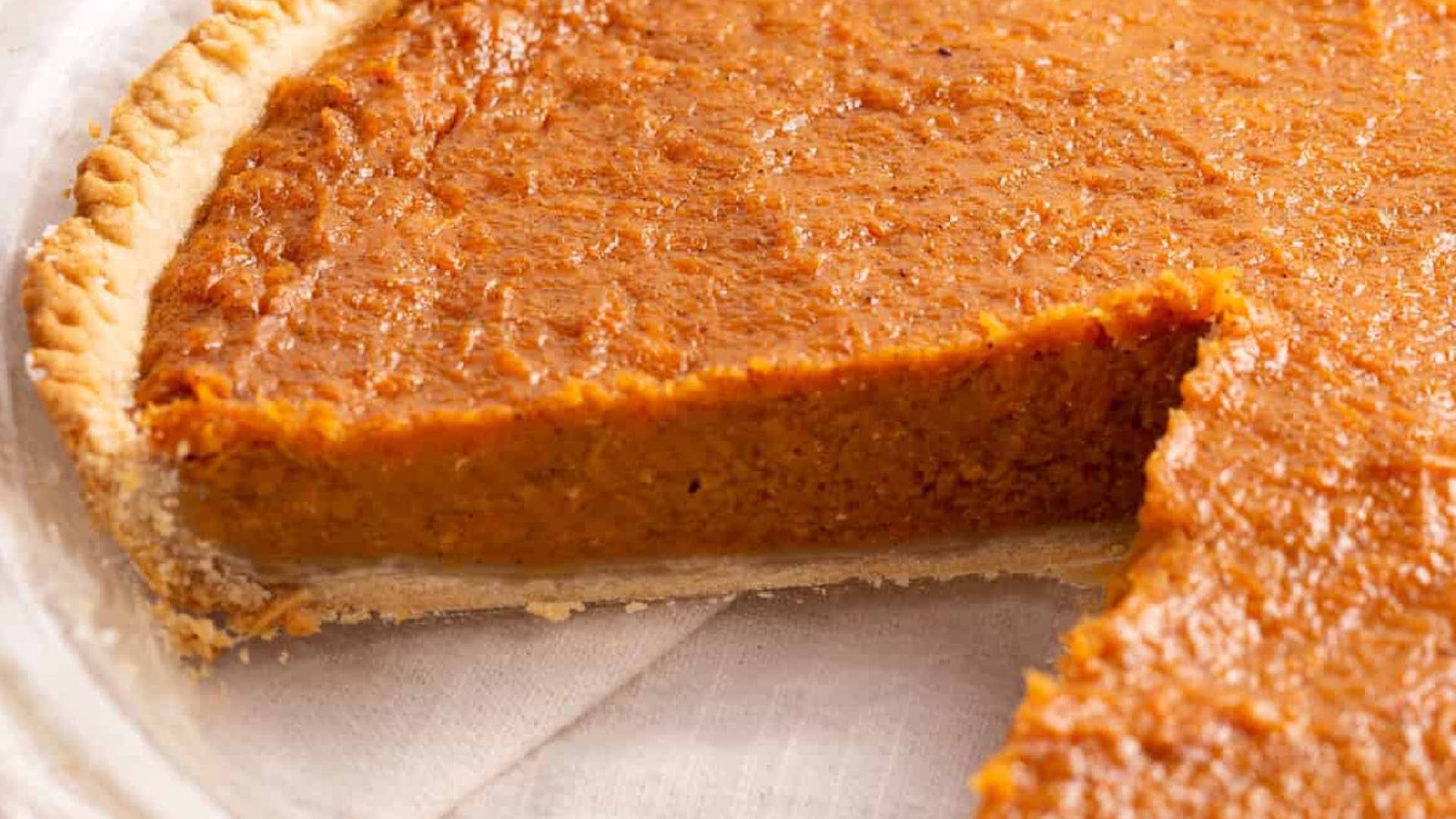 Sweet potato pie with a slice removes. 