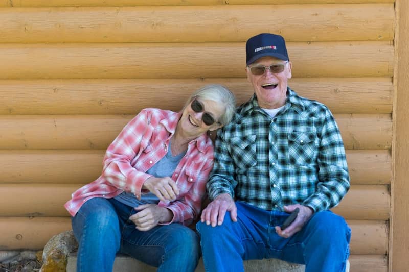 Elderly couple sitting together outdoors