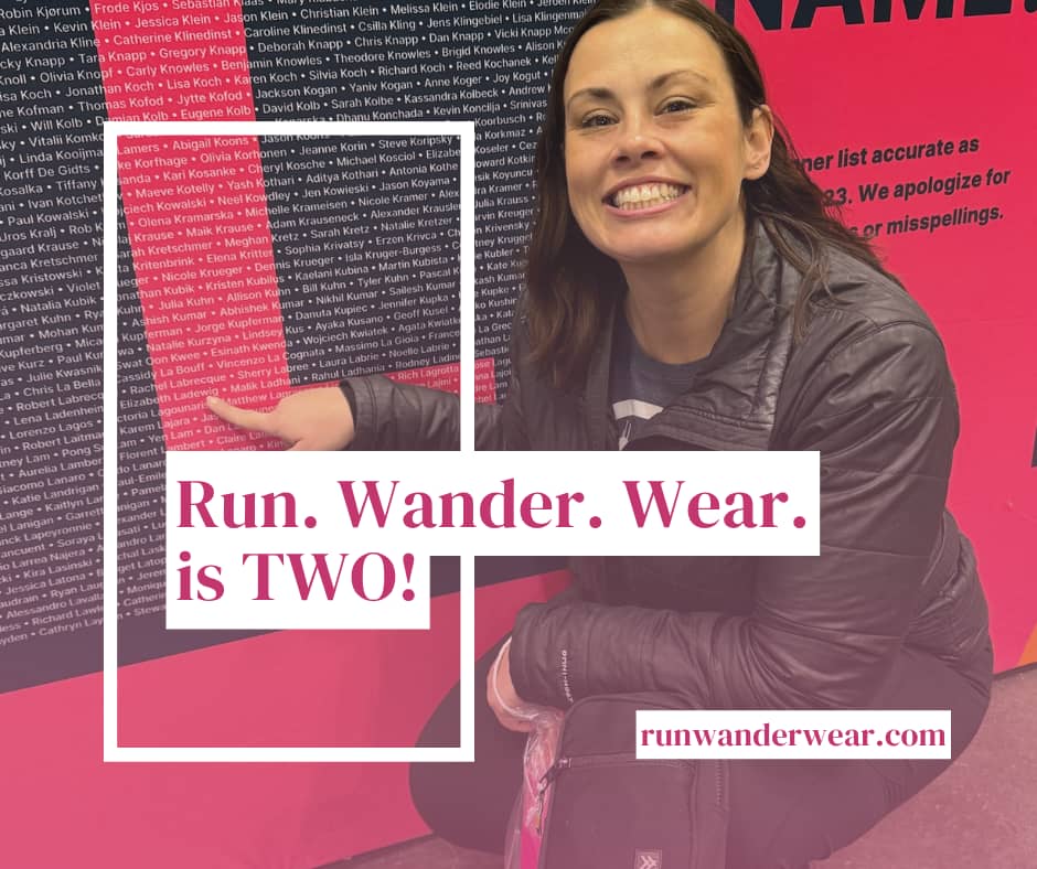 a woman points to her name on a mural, run wander wear is two
