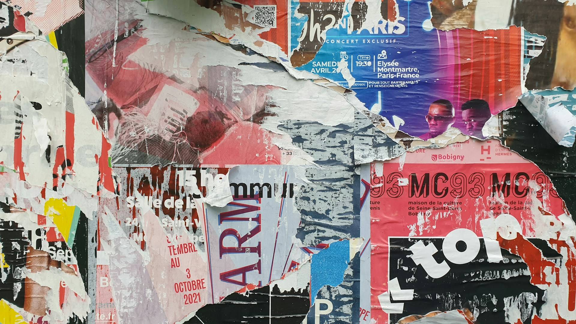 Torn apart posters on a wall