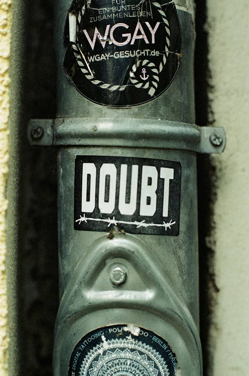 a close up of a parking meter with a sticker on it