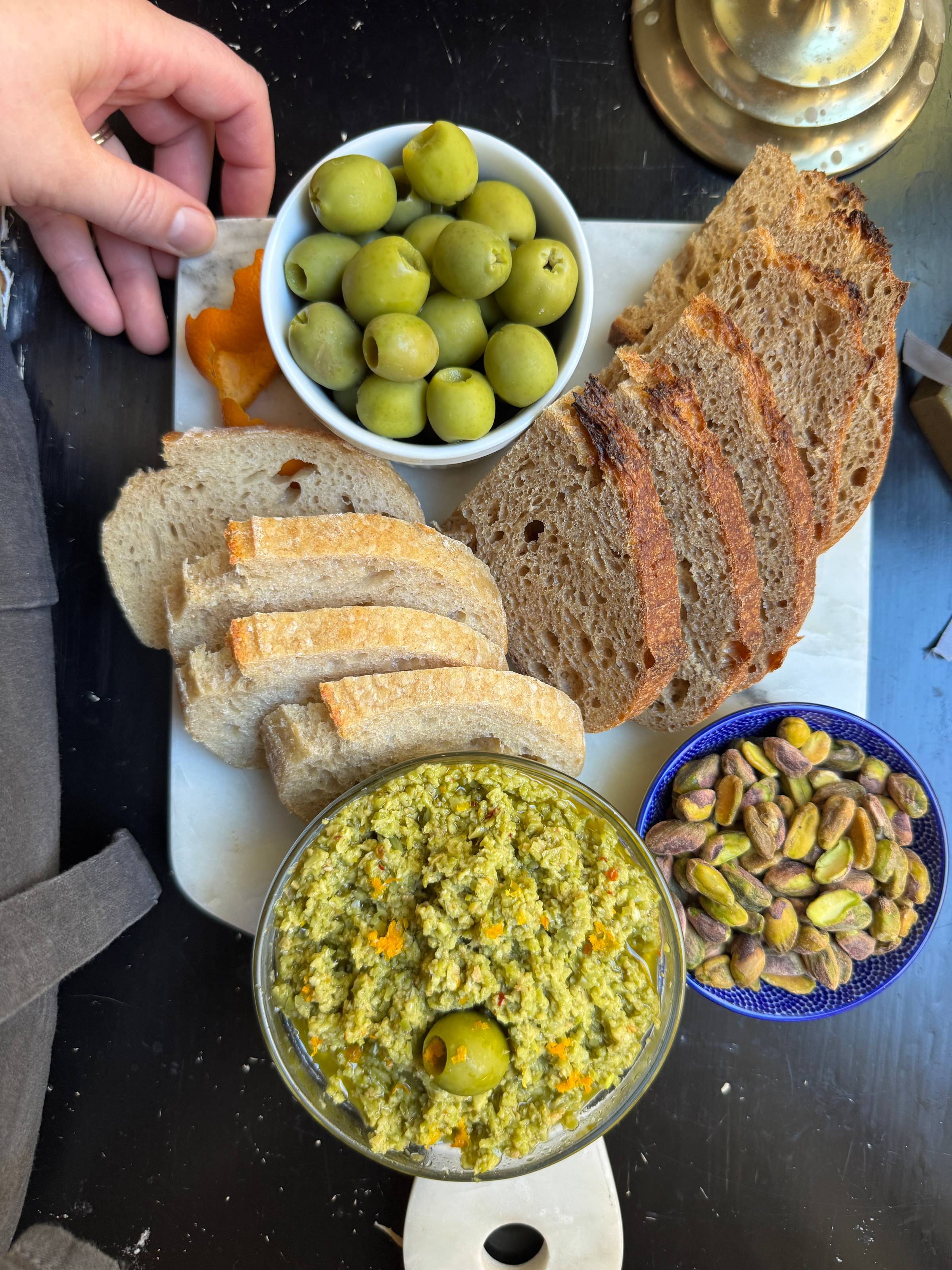 At Home Happy Hour spread: olives, bread, pistachios, tapenade.