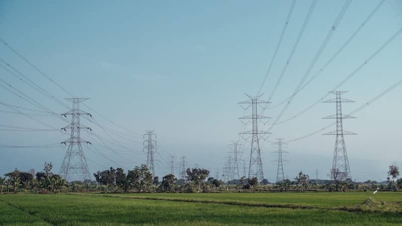 Electric towers and power lines in a field.