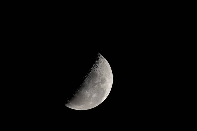 A waxing crescent moon against a dark night sky