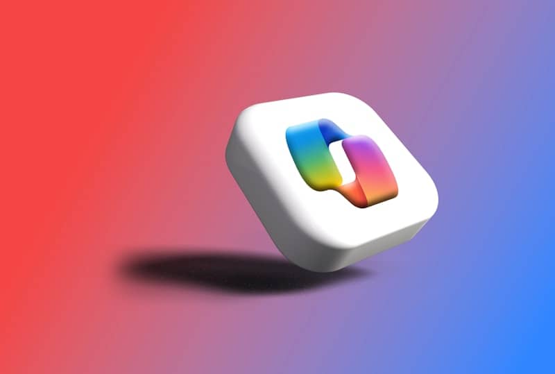 A white cube with a colorful abstract shape inside.