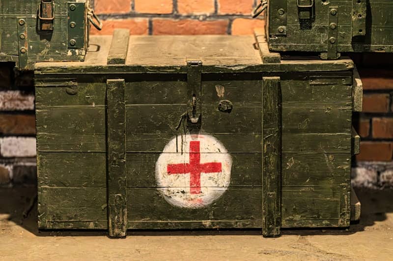 Green wooden chest with a red cross symbol.