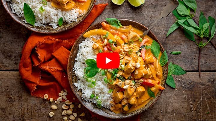 Overhead photo of Chicken Panang Curry in a brown bowl with white rice.